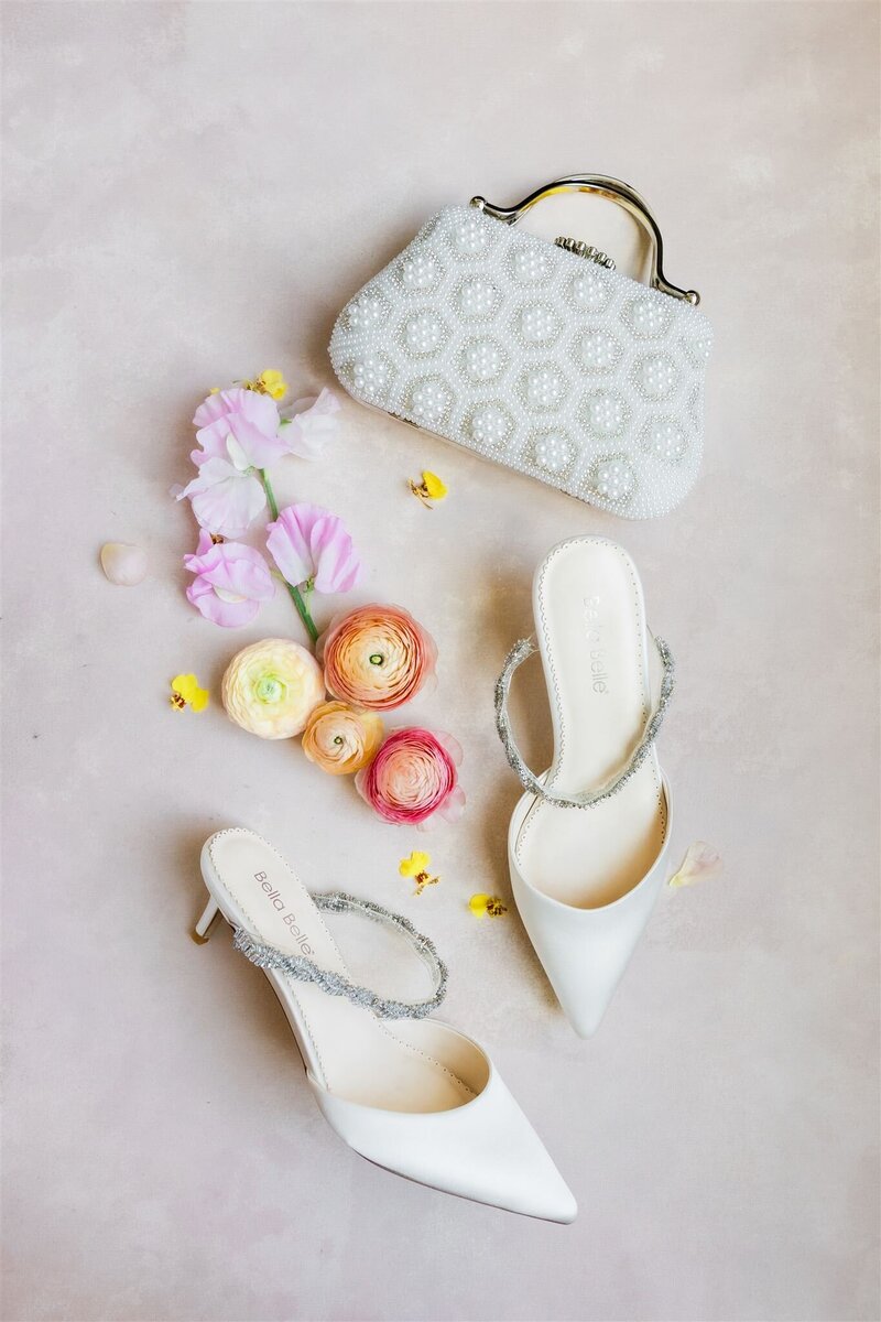 Photo of bride's flatlay details with bright and colorful blooms and a gorgeous invitation suite