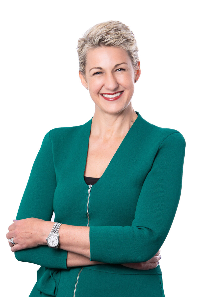 Headshot of a business woman wearing a green jacket