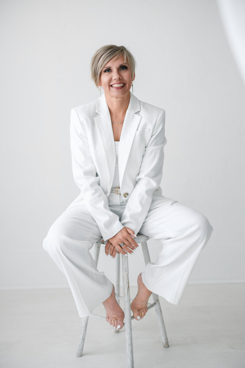 Natalie Clark with red coffee mug at a coffee shop table