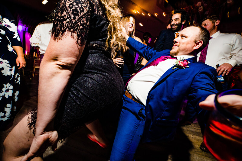 A groomsman dancing with a wedding guest at the reception at The Glass City Center in Toledo Ohio