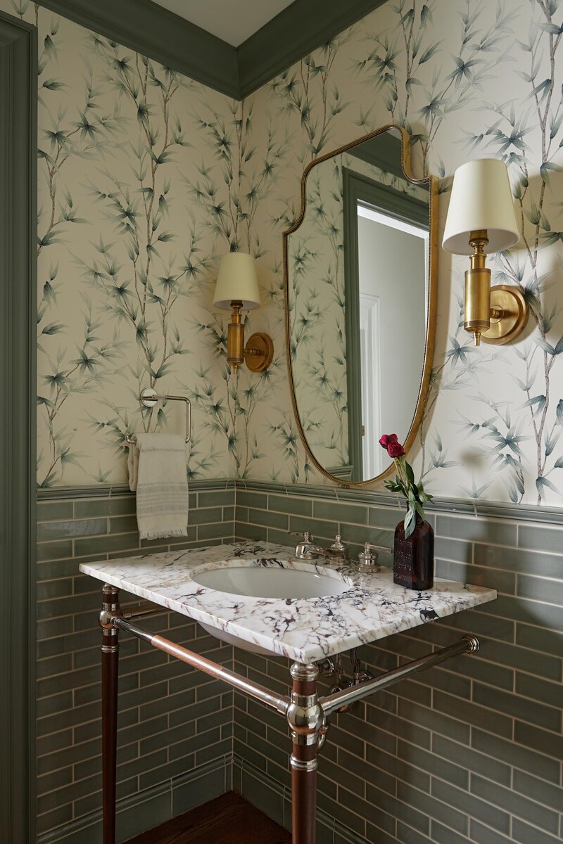 Green powder bathroom with floral wall paper and gold accents