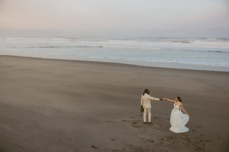 Couple dancing on a secluded sandy beach in Tofino, documented by Vancouver Island intimate wedding and elopement photographer Rae Terrillon.