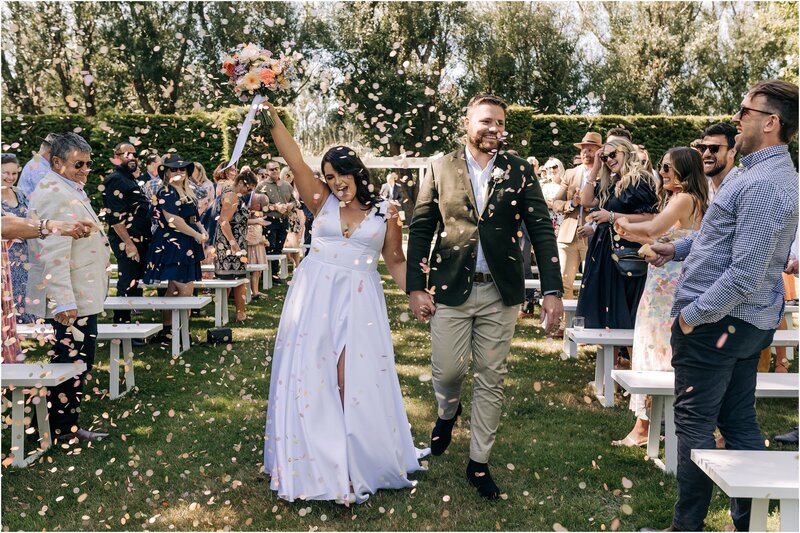 bride clyde new zealand wedding modern summer cape christchurch choker 2022 garden candid posed clasping hands