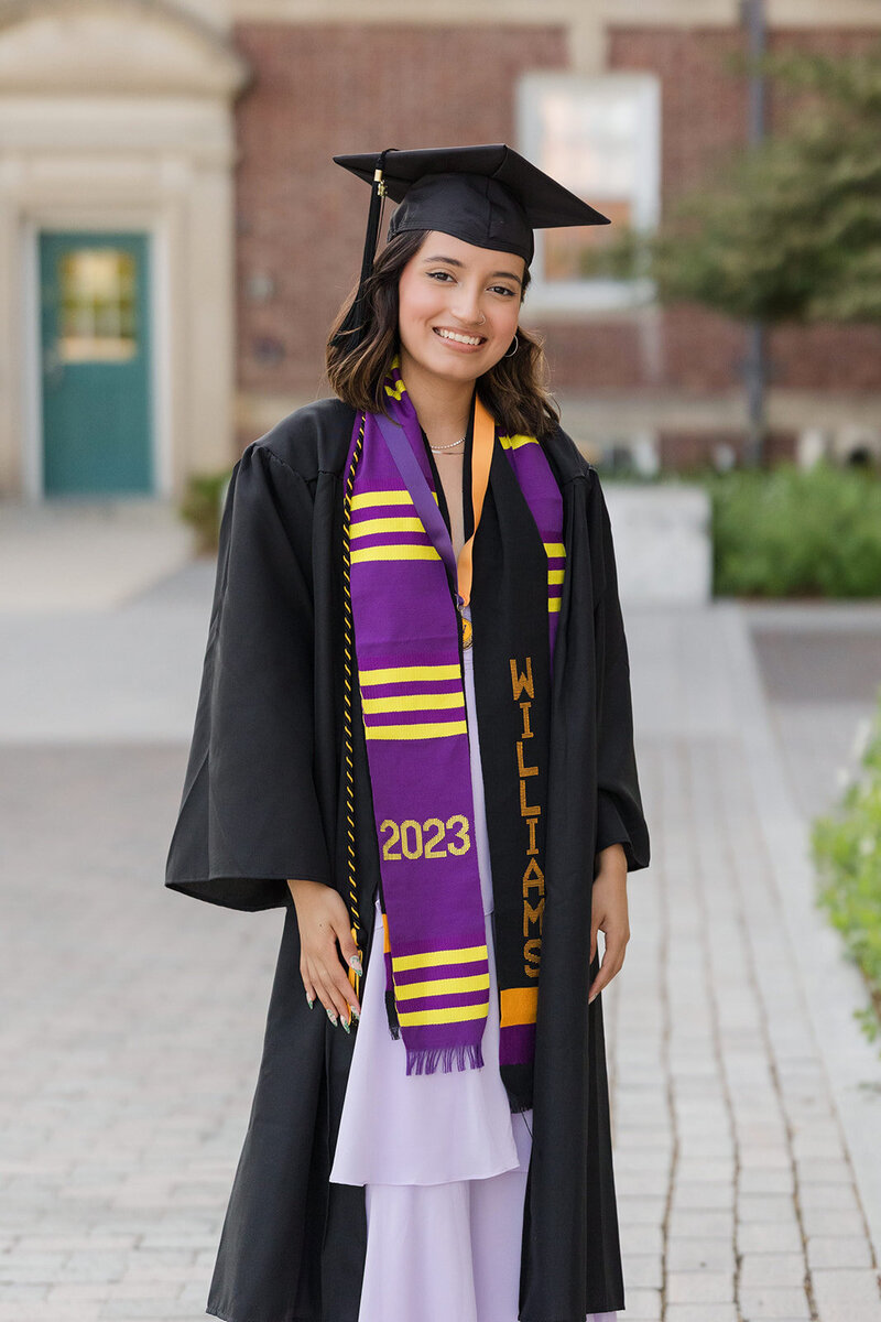 college senior in cap and gown