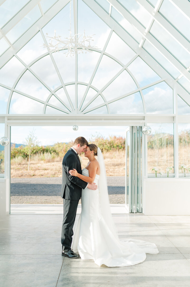 groom hugging bride in wedding venue in spokane washington called farmhouse on greenbluff 