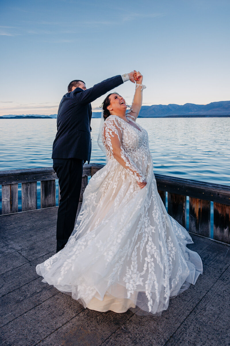 Bride and groom dancing on Flathead Lake dock at Kwataqnuk Resort in Polson, MT