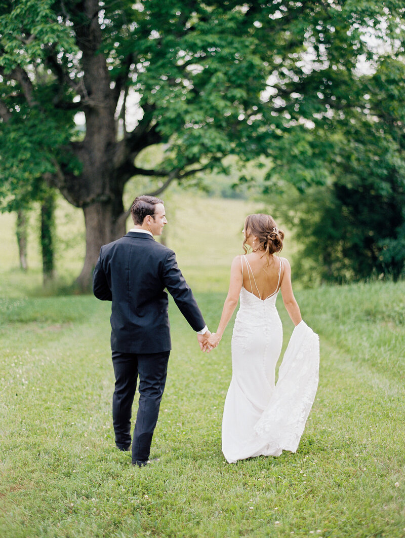 bride-and-groom-walking-in-field