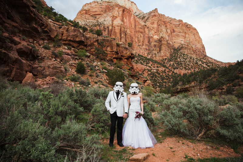 bride and groom wearing storm trooper helmets during outdoor elopement