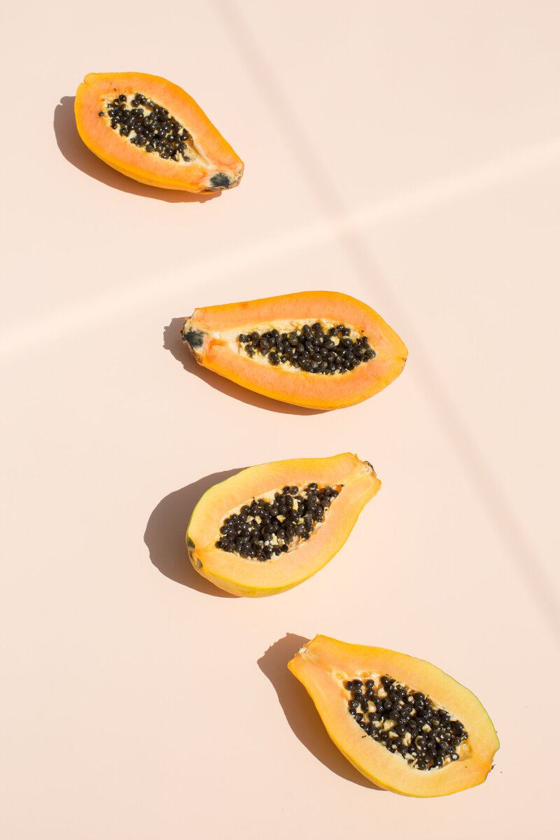 Papayas cut open in half