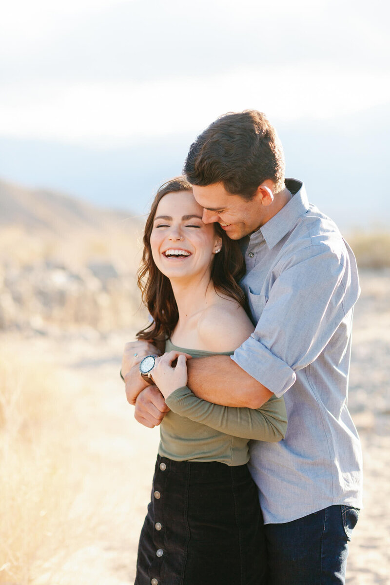 engaged couples at joshua tree laughing candid photo