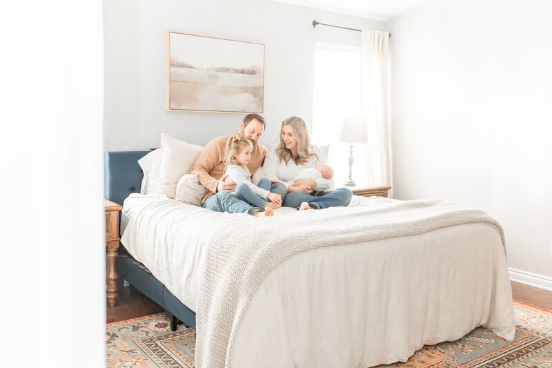 Ann Arbor Maternity Photographer takes photo of family at Lifestyle newborn session.  Mom is wearing dress from client closet from Brooke Leigh Photographer takes in home newborn photos in Ann Arbor Family's home