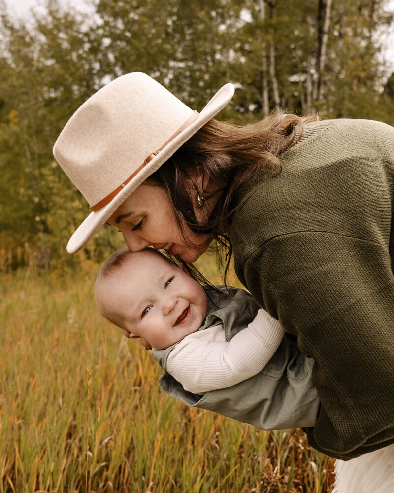 mother kissing baby's head