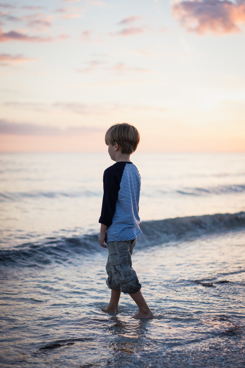Little Boy looking out at water on Sanibel beach
