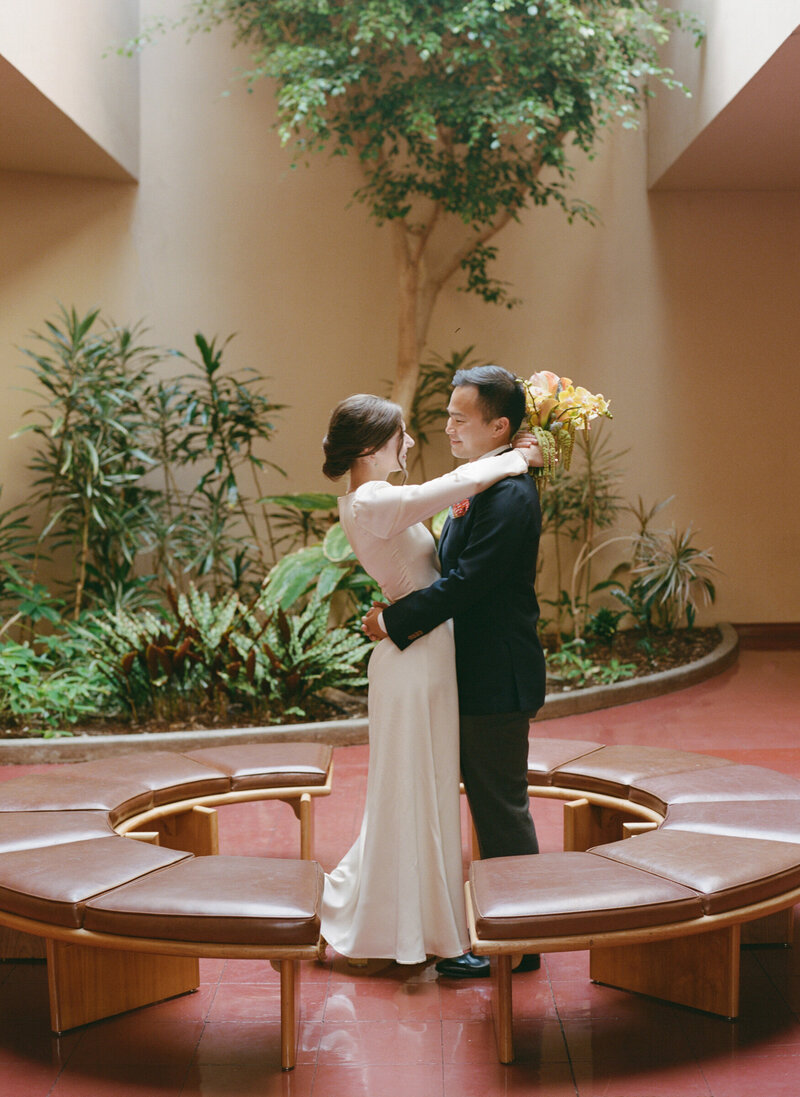 Bride and groom dancing in circular indoor atrium, Marin Civic Center.