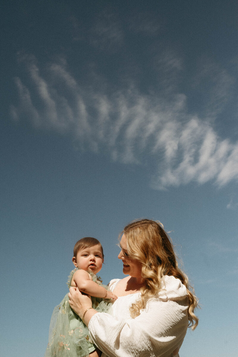 Mother and child laughing together in a beautiful Oregon forest during a 'mommy and me' photoshoot.