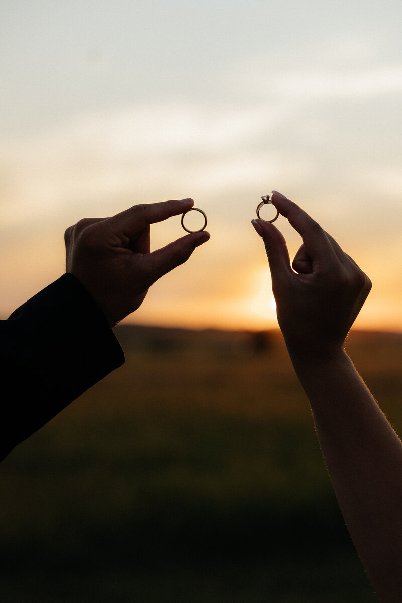 A couple showing off their wedding rings.