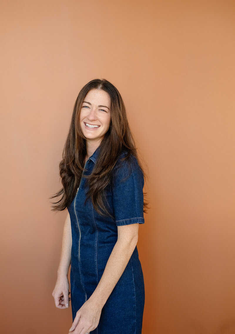 Branding photo of Melissa Stuckey standing holding a camera