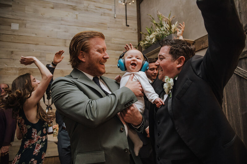 People dancing with a baby at a wedding reception