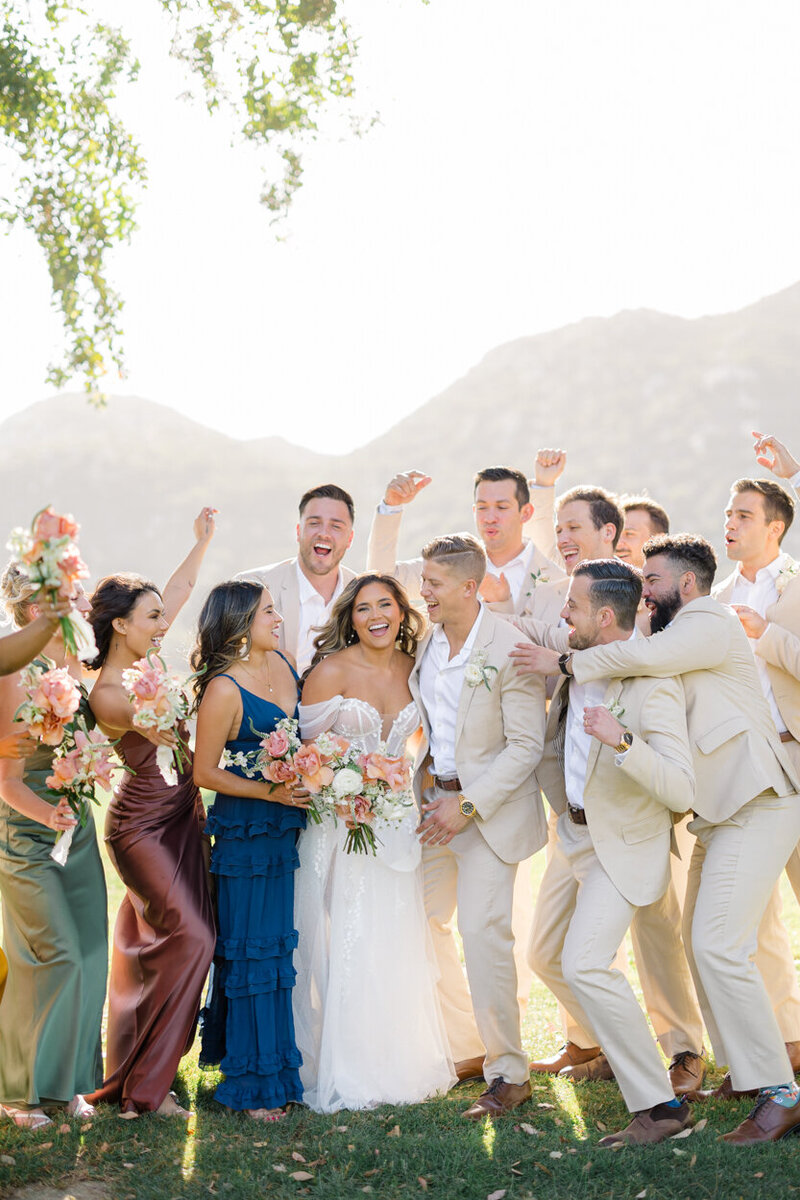 wedding party cheering for the bride and groom