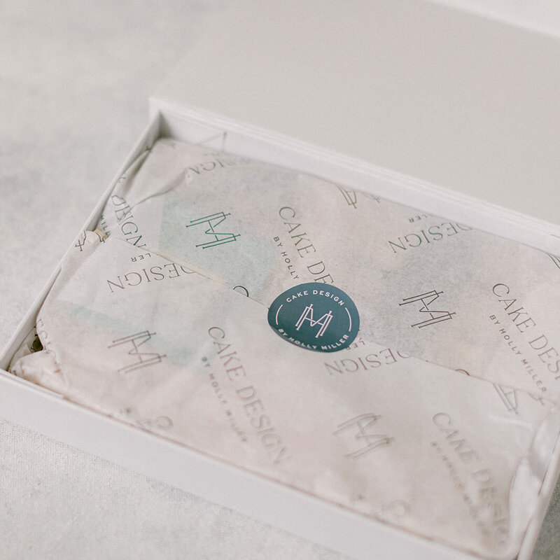 Branded print box for Cake Design by Holly Miller with custom tissue paper and HM monogram stickers