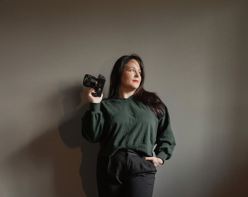 Sarah, lead photographer of Latitude 49 Photography, holding her camera on Vancouver Island.