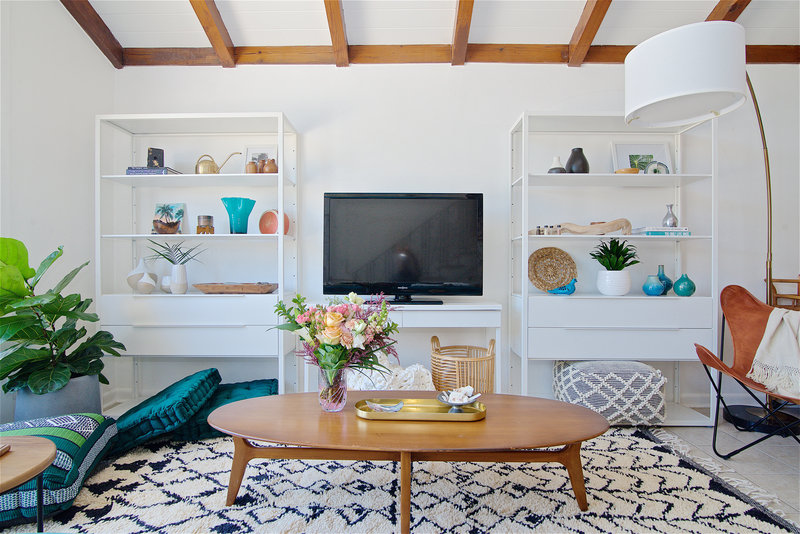 Decorative shelves in a midcentury modern and bohemian influenced living room by Denver based interior designer Fernway & Avalon