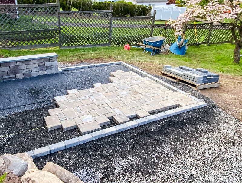 In process photo of installation of a paver patio