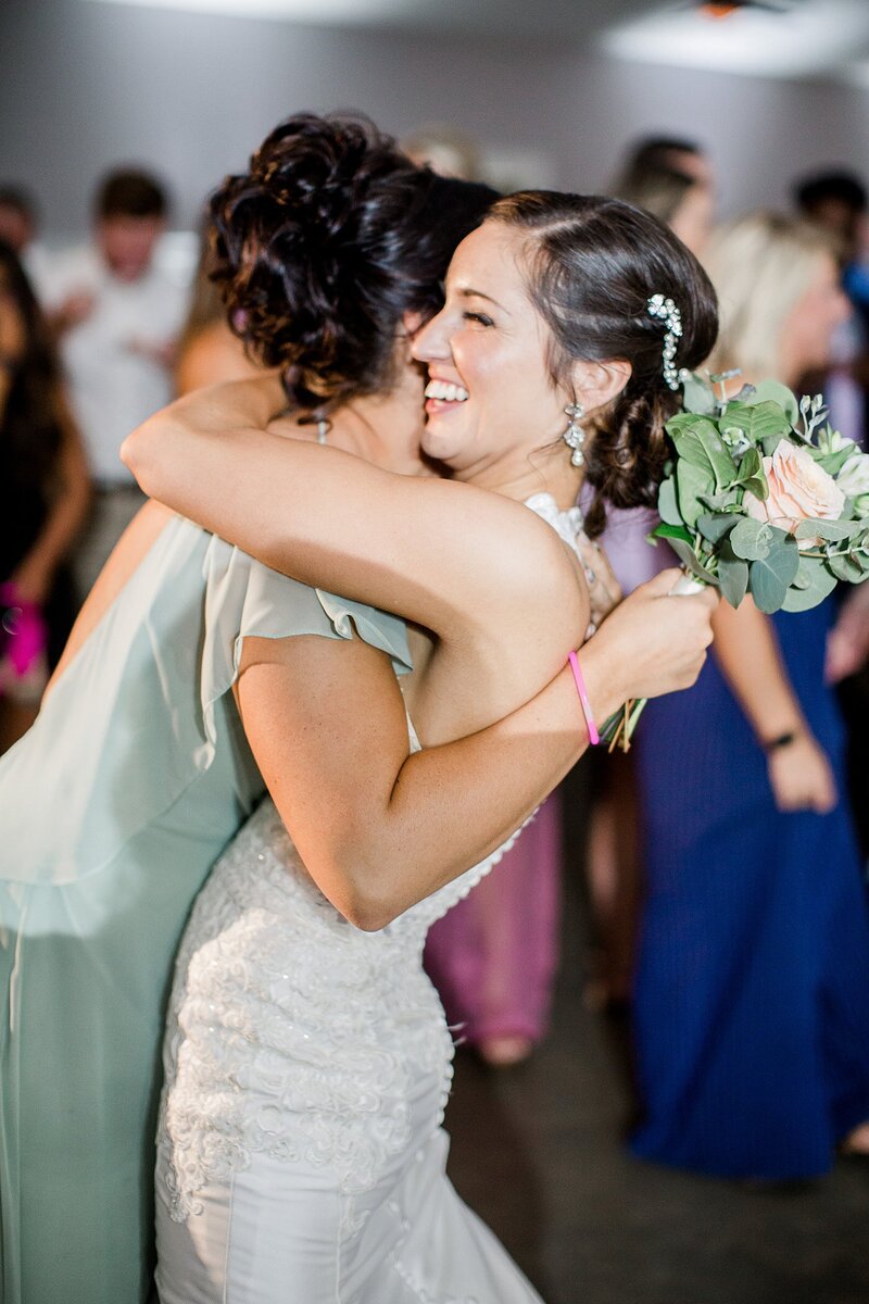 bride hugging bridesmaid by Knoxville Wedding Photographer, Amanda May Photos