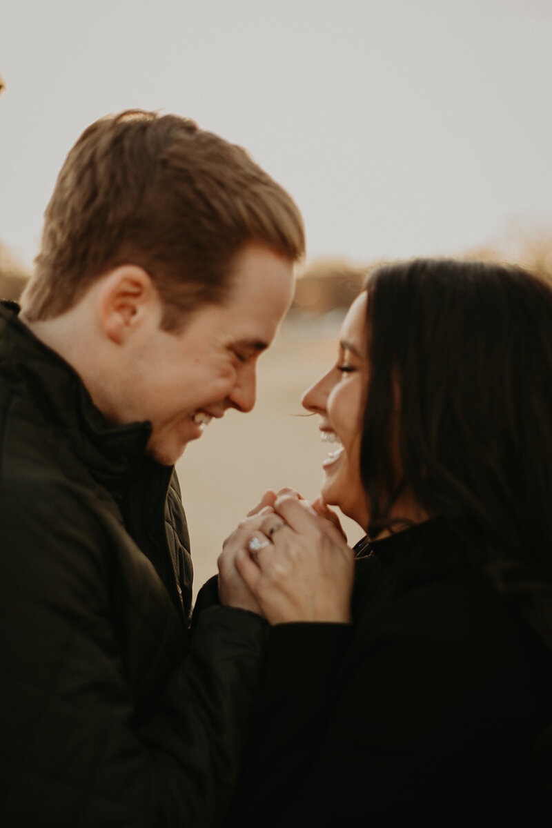 couple laughing at golden hour after proposal