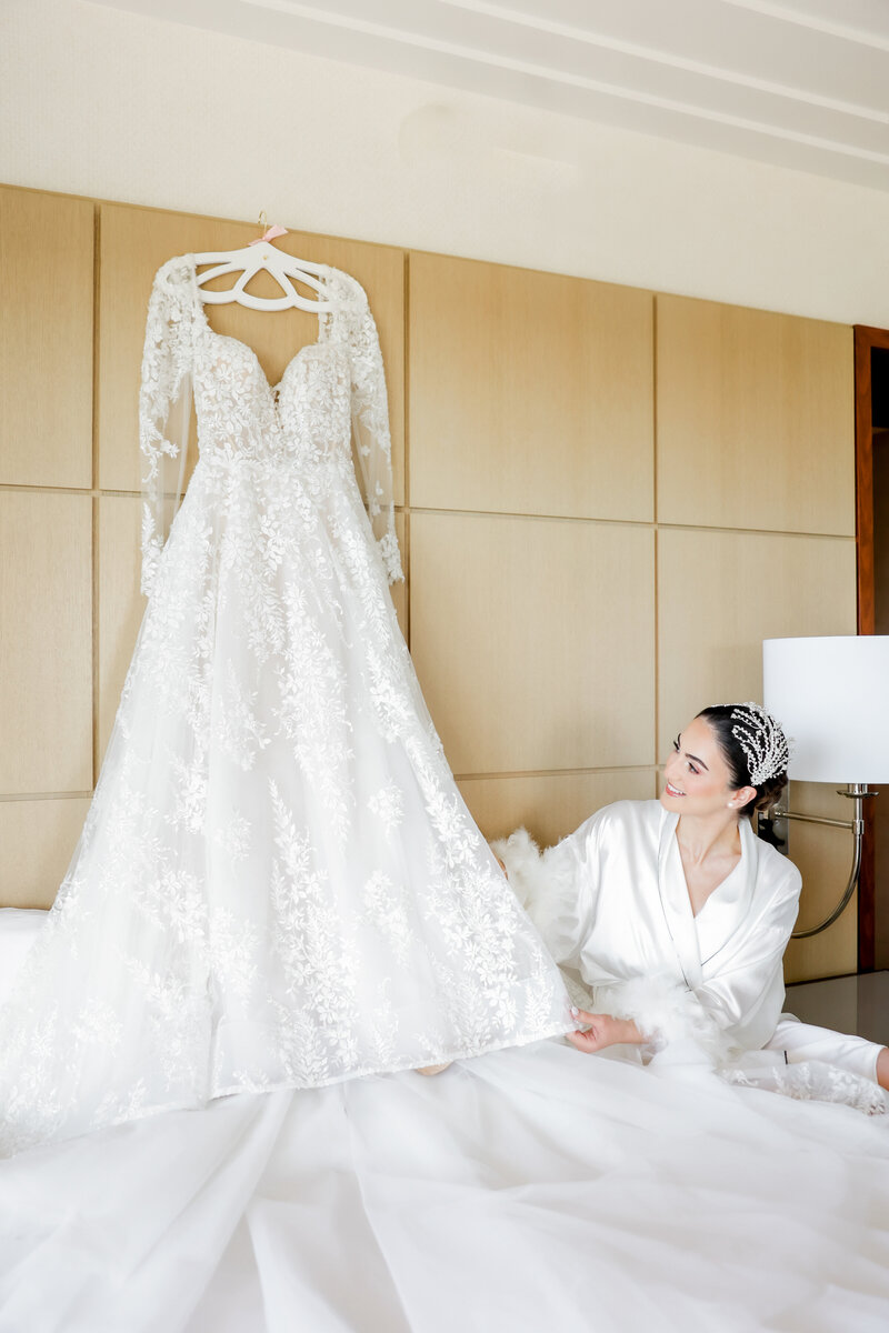 The bride looking at her wedding dress at a wedding at the Four Seasons Orlando by Florida Wedding photographer. 