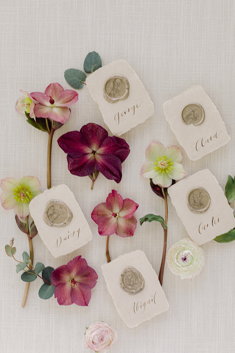 Natural linen flat lay mat with vintage stamps and florals for wedding styling