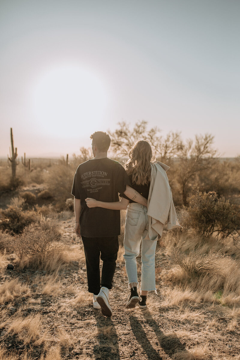 couple walking into the sunset in the desert