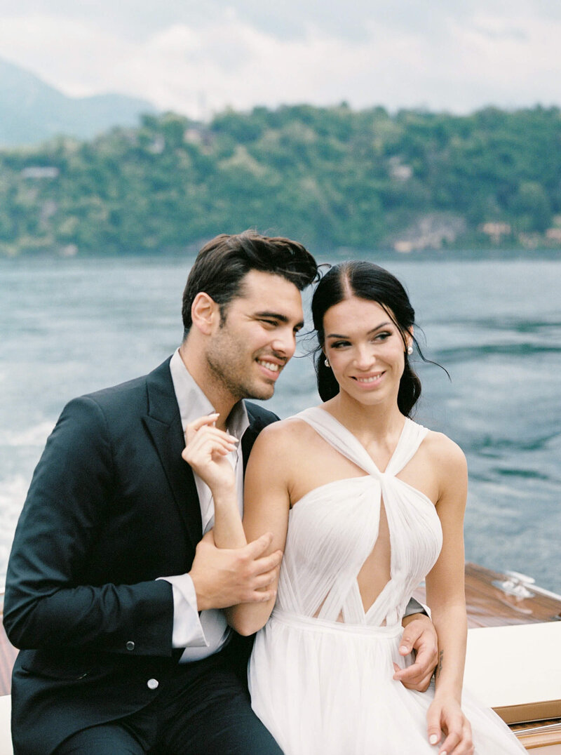 A wedding photo of the couple on a boat on the way to their wedding venue Villa Balbiano
