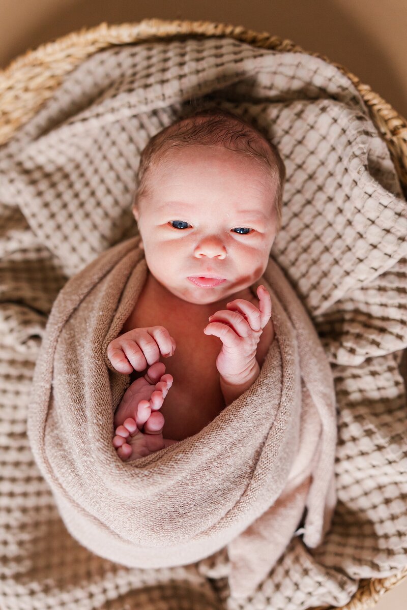 Newborn baby swaddled in soft blankets during a heartfelt in-home photography session in Staunton, Virginia