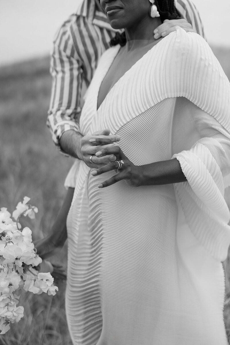 Couple hold hands with wedding ring, Nantucket wedding. Deborah Zoe Photography.