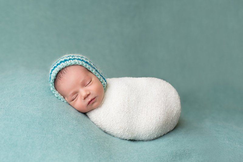 baby boy wrapped teal blue white