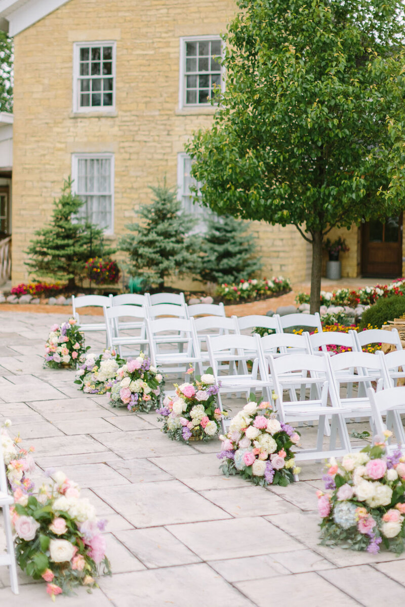 Wedding reception with white chairs and flowers