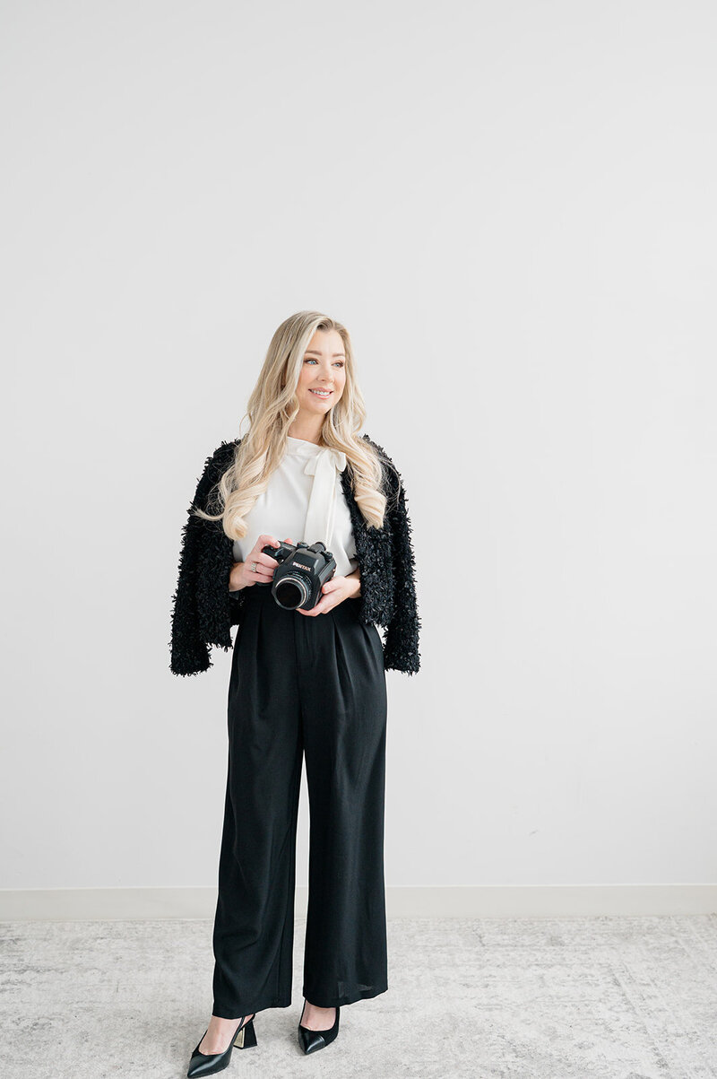 a woman smiling in a black outfit