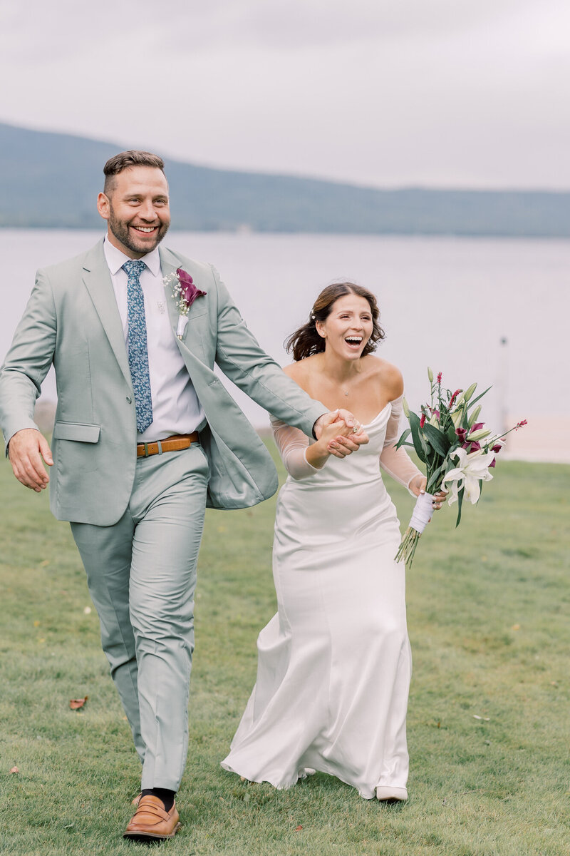On the top of an Adirondack mountain, a bride shares her wedding vows with her groom on their intimate elopement during peak Fall foliage in Upstate New York
