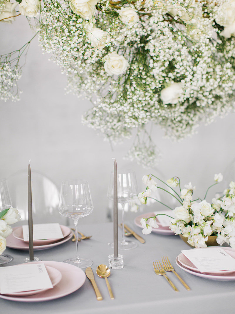 This modern blush pink table scape uses babys breath tastefully