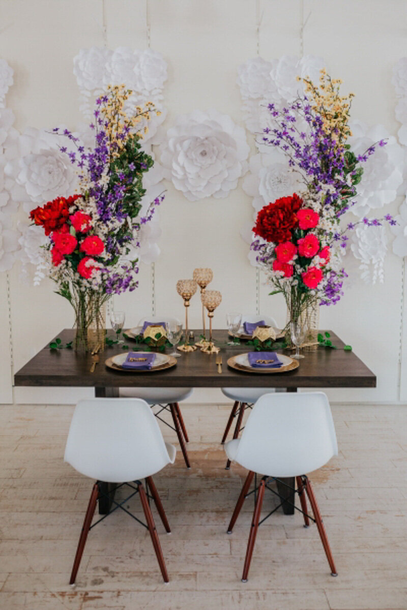 Wooden table designed with red, purple and yellow flowers
