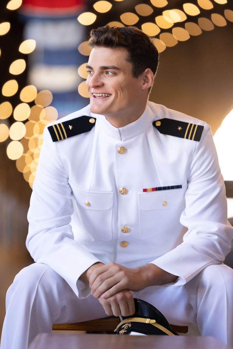 USNA Midshipman in white uniform on the steps of Bancroft Hall for photo by Kelly Eskelsen.