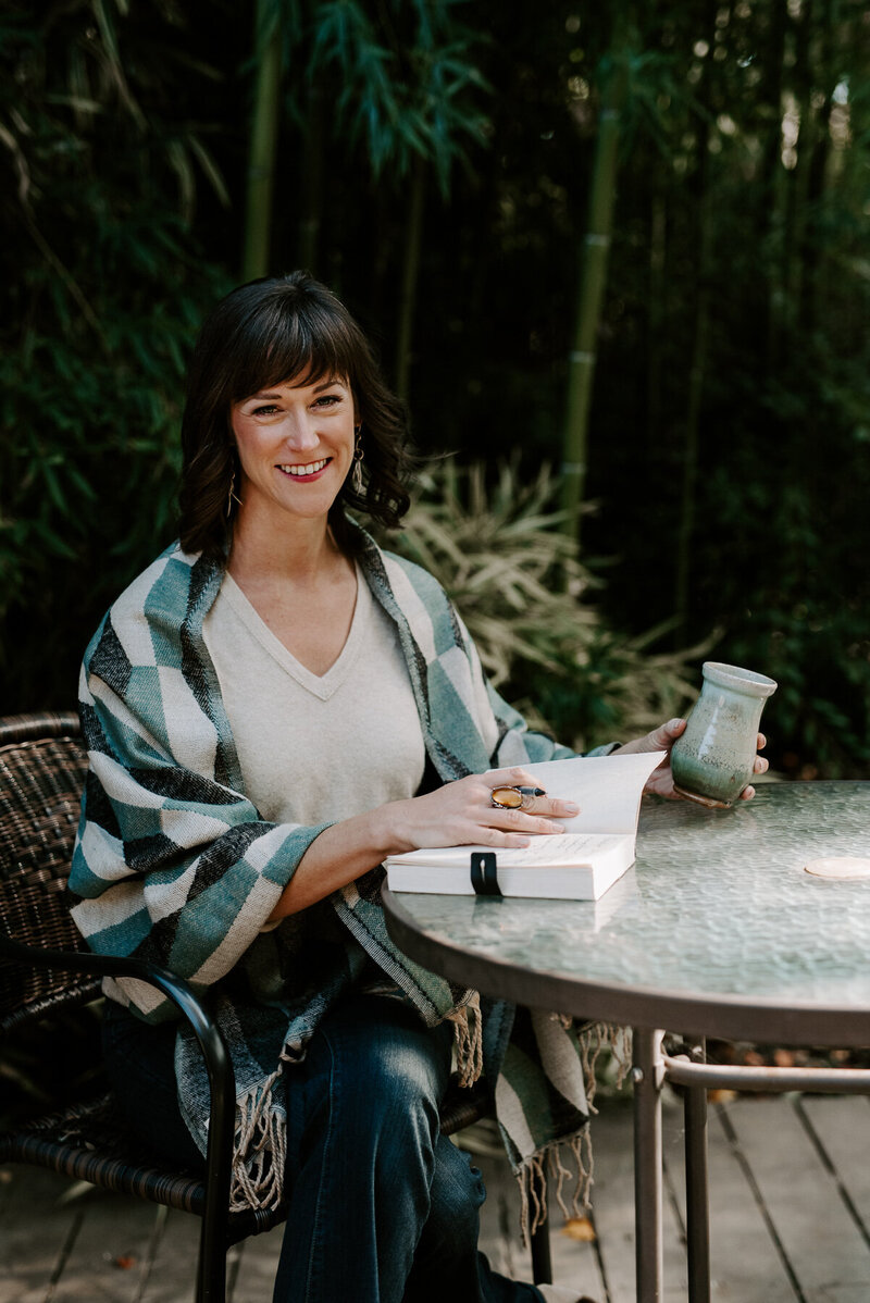Woman sitting at table with coffee outside