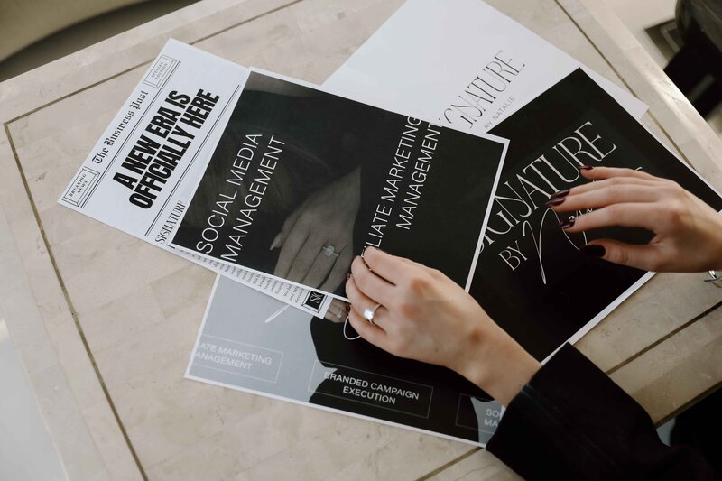 Natalie Jone's hands laying on top of branding materials 