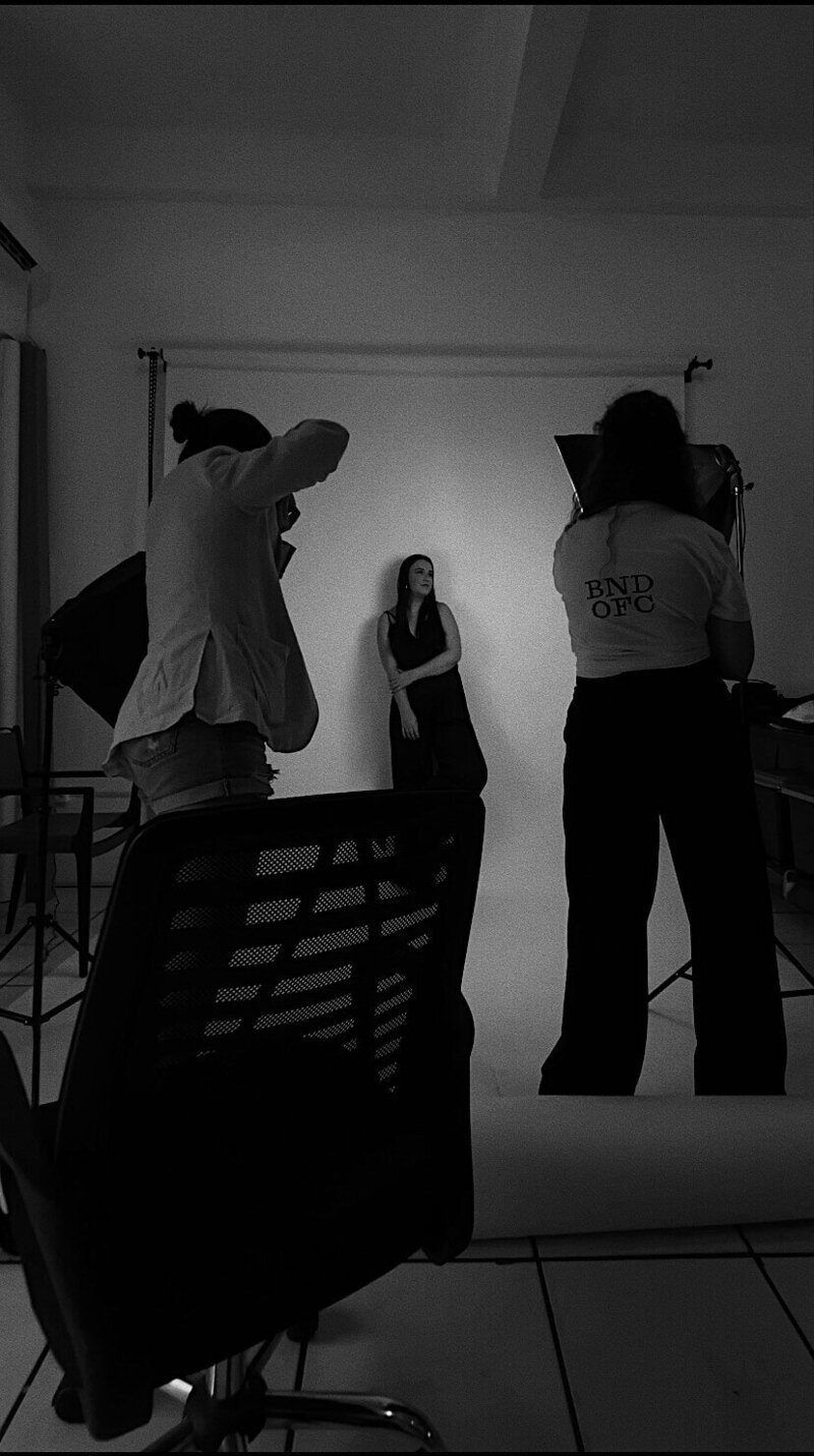 Woman in studio getting photographed, representing production services of Good Girl Bad Girl Studios. 