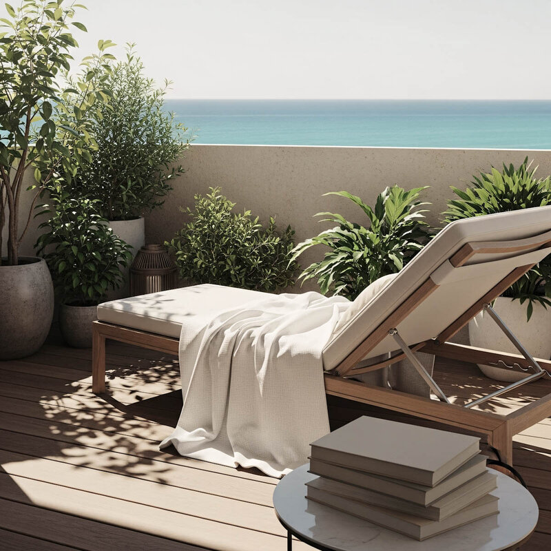 Serene oceanfront terrace with lounge chair awaiting travelers arrival at destination. Tailored Oasis Travel Co.