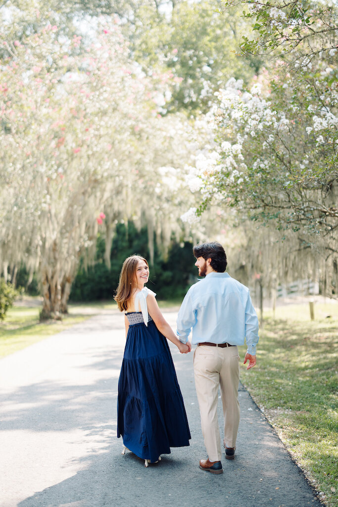 Couple enjoying a romantic moment during their engagement session at Rosedown Plantation, captured by Morgan Alysse, Louisiana wedding photographer.