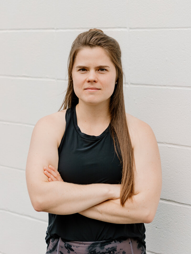 woman crossing arms and looking at camera
