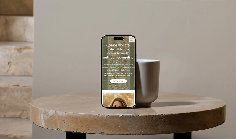 Mockup of an iPhone displaying a nutritionist website design with vibrant colors and user-friendly design.