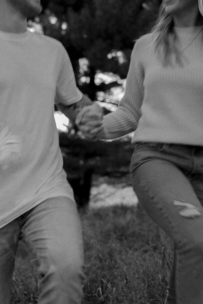 Couple's engagement session in Omaha during golden hour, surrounded by warm fall foliage – captured by Tori Nichole Photography. Authentic, romantic moments in a stunning autumnal setting, reflecting the beauty of the season and their love story.
